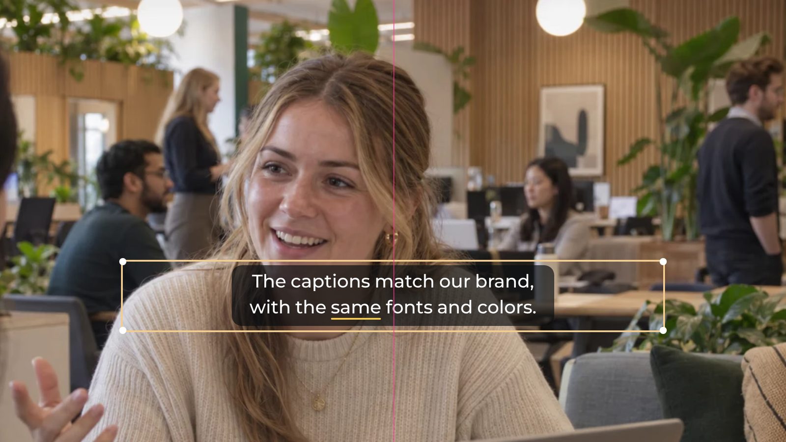 A caption being dragged on the video, with its selection box, corner handles and a pink guide marking the centre