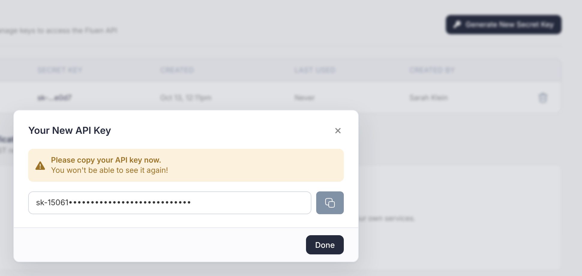The API and Webhooks settings page with the Your New API Key dialog open, the key partly hidden, the copy button and the reminder that it will not be shown again
